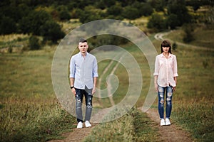 Young Couple is having fun on their summer holiday. stylish man and woman are jumping, running and enjoy summer day out of city