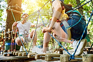 Young couple having fun time in adventure rope park.