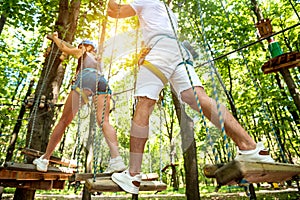 Young couple having fun time in adventure rope park.