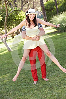 Young Couple Having Fun Together In Garden