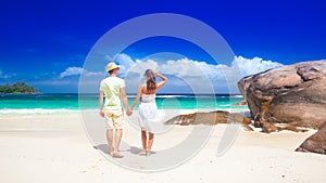 Young couple having fun at tropical Baie Lazare beach at Mahe island, Seychelles