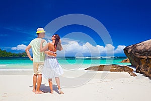 Young couple having fun at tropical Baie Lazare beach at Mahe island, Seychelles