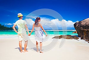 Young couple having fun at tropical Baie Lazare beach at Mahe island, Seychelles