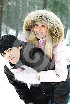Young couple having fun in winter park