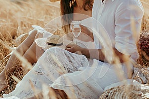 Young couple having goodtime during picnic in the meadow photo