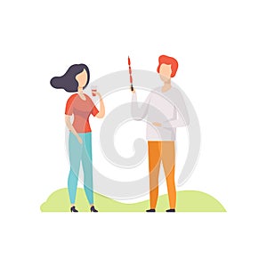 Young couple having outdoor bbq party, girl standing with plastic cup of drink, man holding a skewer with grilled