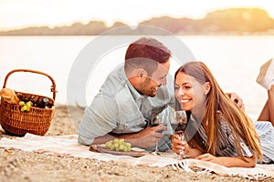 Young couple having a picnic at the beach