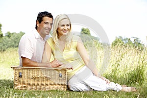 Young couple having picnic in countryside