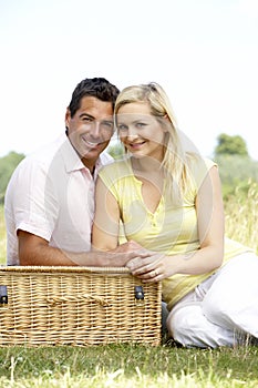 Young couple having picnic in countryside