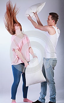 Young couple having pillow fight