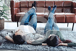 Young Couple Having Relaxing While Lying on Carpet at Their Home, Attractive Asian Couple Love are Relaxed Together at Home Living