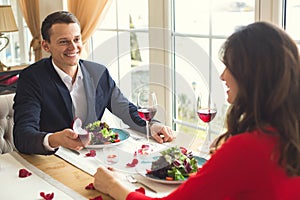 Young couple having romantic dinner in the restaurant proposal ring