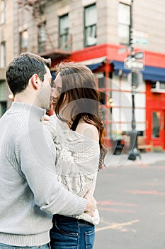 A young couple having a romantic moment in front of  famous