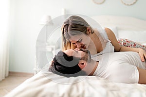 Young couple having romantic time in bedroom