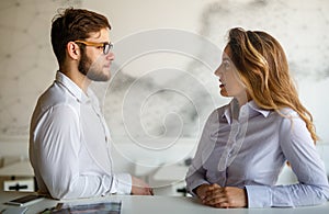 Young couple having serious relations communication problems.