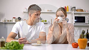 Young couple having snack together before work, light dessert with coffee