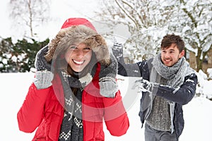 Young couple having snowball fight