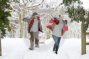 Young couple having snowball fight