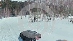 Young couple having snowball fight and kiss