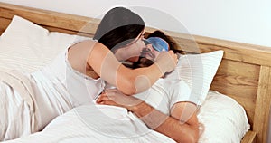 Young couple having tender moments at morning time after waking up inside the bed - Love, home lifestyle and