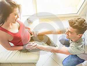 Young couple having tender moments while waiting for a baby - Happy lovers enjoying time together at home - Focus on hands - Love