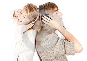 Young couple in headphones listening music