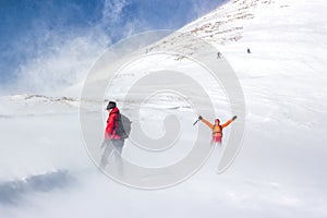 Young couple hiking in a snowed mountain