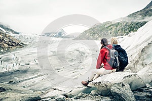 Young couple hiking in the swiss alps, taking a break