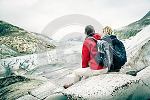 Young Couple Hiking In The Swiss Alps, Taking A Break