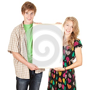 Young couple holding blank billboard