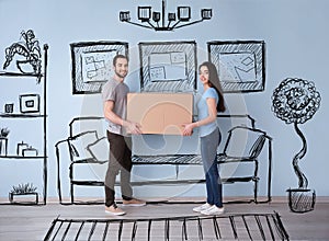 Young couple holding box indoors and imagining interior of new house. Moving day