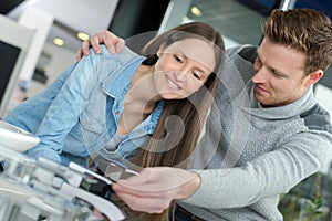 young couple holding credit card together