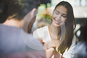 Young couple holding hands in cafe