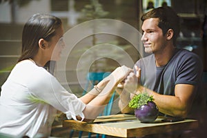 Young couple holding hands in cafe photo