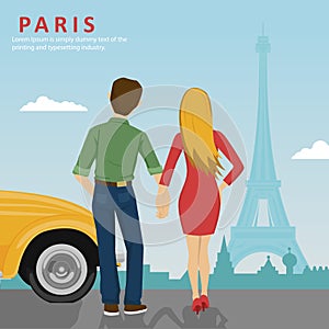 Young couple holding hands standing next to yellow car looking at Eiffel Tower in Paris
