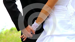 Young couple holding hands standing together in park