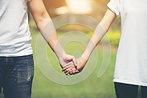 Young Couple Holding Hands Walking Away together.