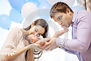 Young couple holding and kissing newborn baby boy