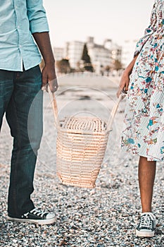 Young couple holding picnic basket