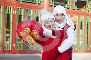 Young couple holding red lantern