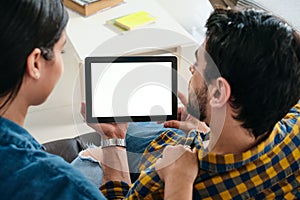 Young Couple Holding Tablet With Blank Screen For Copy Space