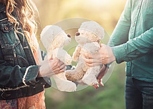 Young couple holding two teddy bears