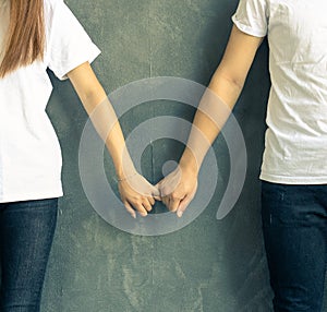 Young couple holds hands affectionately