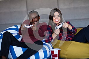 Young Couple at home Playing Video Game Together