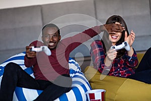 Young Couple at home Playing Video Game Together