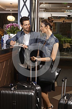 Young couple at hotel reception