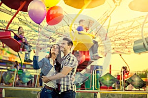 Young couple hugging in amusement park