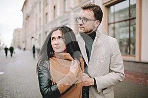 Young couple hugging on the city street in winter