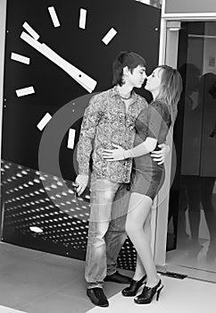 Young couple hugging by clock