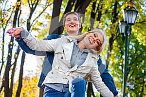 Young couple hugging and flirting in park.